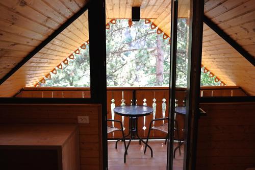 a room with a table and a window in a cabin at Greenwood in Borjomi