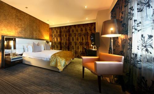 a hotel room with a bed and a chair at Coastlands Umhlanga Hotel and Convention Centre in Durban
