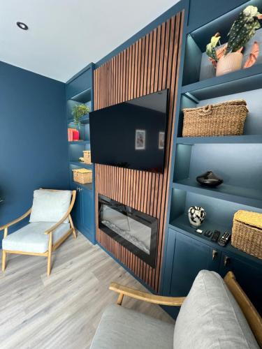 a living room with a fireplace and a chair at 13 barley view luxury property in Bristol