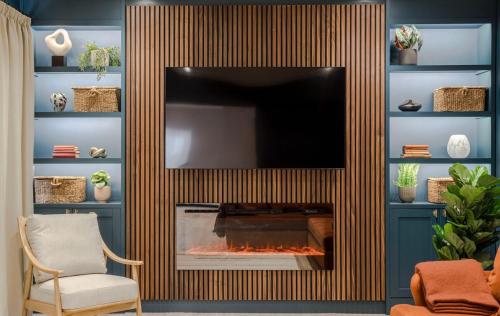 a living room with a fireplace with a flat screen tv at 13 barley view luxury property in Bristol