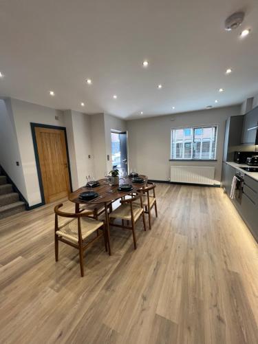 a large room with a table and chairs and a kitchen at 13 barley view luxury property in Bristol