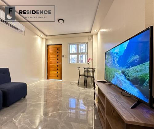 a living room with a large flat screen tv at F Residence Transient House in Cabanatuan