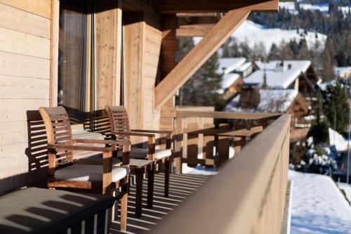 a row of chairs sitting on the balcony of a house at No 14 Verbier in Verbier