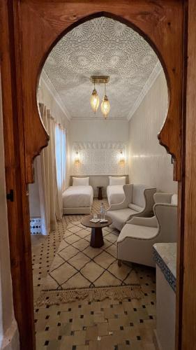 a living room with a couch and a table at Riad Aslal in Marrakech