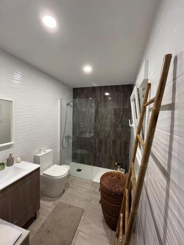 a bathroom with a shower and a toilet and a sink at Casa do Avô Ezequiel in Vendas Novas