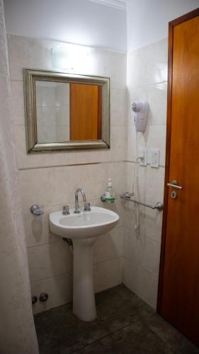 a bathroom with a sink and a mirror at Departamentos Sol y Arena in San Clemente del Tuyú