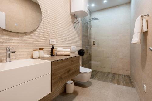 a bathroom with a sink and a toilet and a shower at Apartmani Laguna in Neum