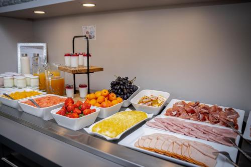 a buffet with many different types of food on a table at Logis Hôtel Le Régal & Spa in Saint Die