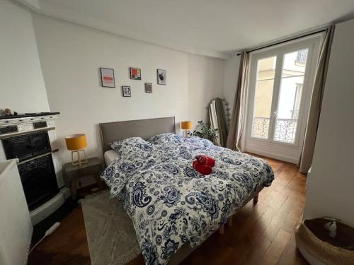 - une chambre dotée d'un lit avec un ours en peluche rouge dans l'établissement Design flat for 4 people Paris 18 close to Montmartre, à Paris