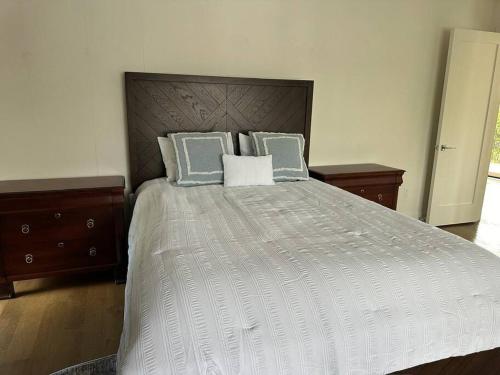 a bedroom with a large bed with blue and white pillows at Hudson River Valley Estate New Listing in Verplanck