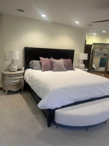a bedroom with a large bed and a mirror at Hudson River Valley Estate New Listing in Verplanck