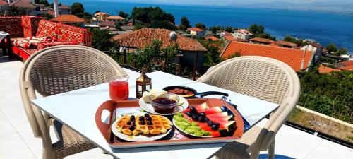 a tray of food on a table on a balcony at Vila Sela in Shkodër