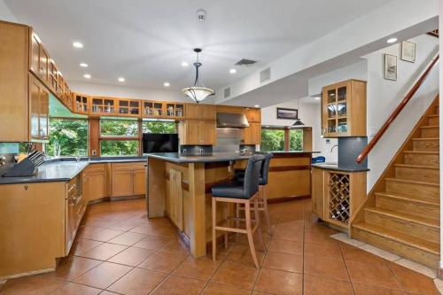 a large kitchen with a counter and a staircase at Hudson River Valley Estate New Listing in Verplanck