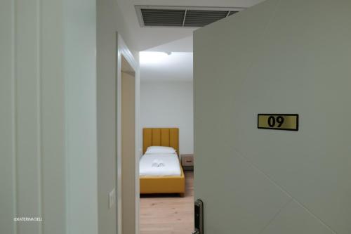 a bedroom with a bed in a white room at Comfort Rooms Pogradec in Pogradec