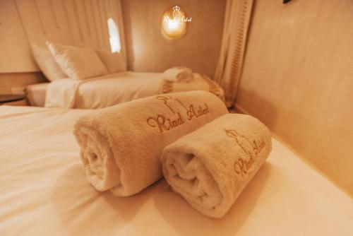 two towels on a bed in a hotel room at Riad Aslal in Marrakech