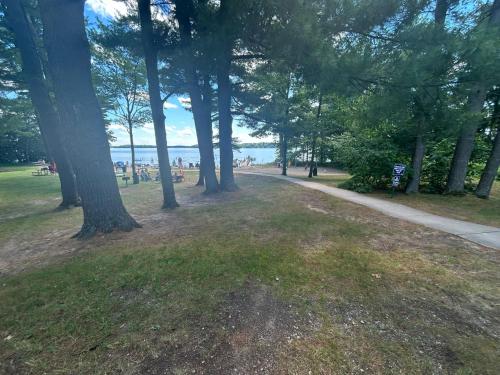 a park with trees and a path in the grass at LAKEFRONT PARADISE 4 bedroom Home w direct lake access, Pets OK in Traverse City