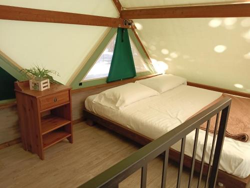 a small bedroom with a bed and a window at Parco Del Lago Glamping And Camping in Anguillara Sabazia