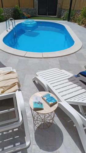 a pool with a table with a cake on it at M&S Paradise Bilice, Šibenik in Vrulje