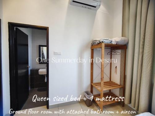a bathroom with aiger sized bed and a mirror at One Summerday in Desaru in Kangkar Chemaran