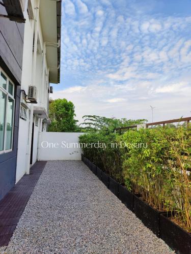 a walkway in front of a building at One Summerday in Desaru in Kangkar Chemaran