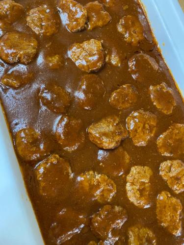 a tray of food with meatballs in a sauce at Madarao Lainstons in Iiyama