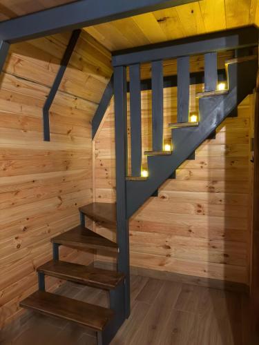 a staircase in a cabin with wood walls at ZeRa Suit Bungalov Rize in Ardeşen