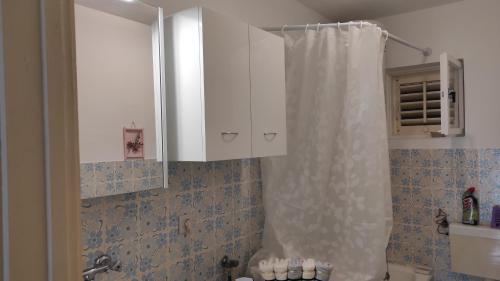 a bathroom with a shower and a white cabinet at Apartman Iva in Kaštela