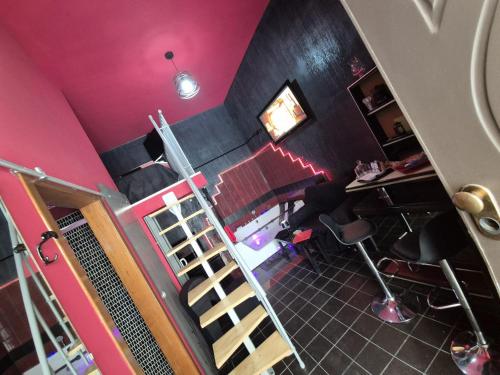 an overhead view of a room with pink walls and a ladder at Nouvelle Maison Relax in Leonforte