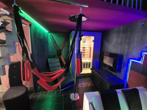 two hammocks in a room with purple and green lights at Nouvelle Maison Relax in Leonforte