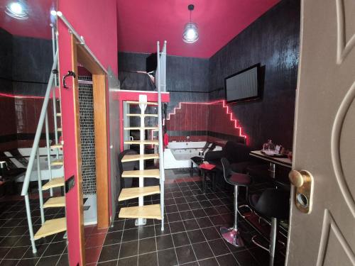 a room with a bunk bed and a desk and chairs at Nouvelle Maison Relax in Leonforte