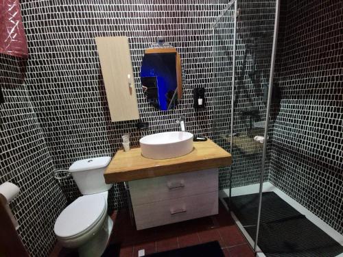 a bathroom with a toilet and a sink and a shower at Nouvelle Maison Relax in Leonforte