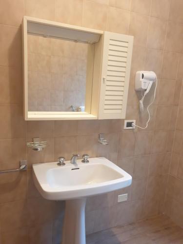 a bathroom with a sink and a mirror at Locanda In Montagna Da Emili&Gabriel in Lizzano in Belvedere