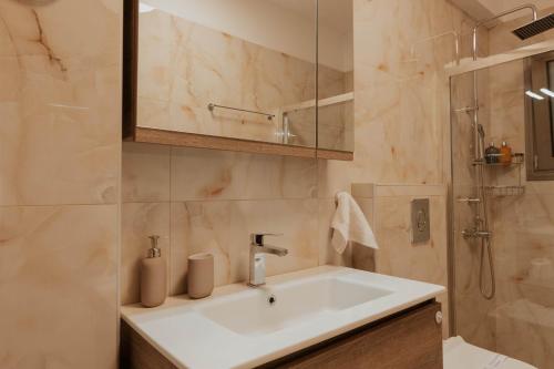 a bathroom with a sink and a shower at Dantis Place Alpha1 in Nafplio