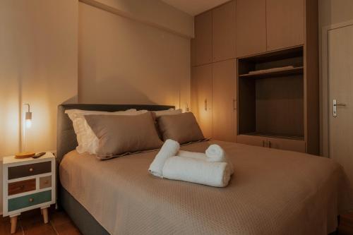 a bedroom with a bed with a white towel on it at Dantis Place Alpha1 in Nafplio