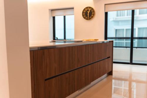 a kitchen with a wooden counter and a clock on the wall at Sea Front - Spacious - Beautiful in Sliema