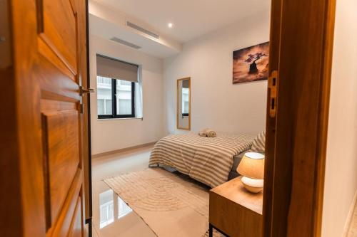 a bedroom with a bed and a table and a door at Sea Front - Spacious - Beautiful in Sliema