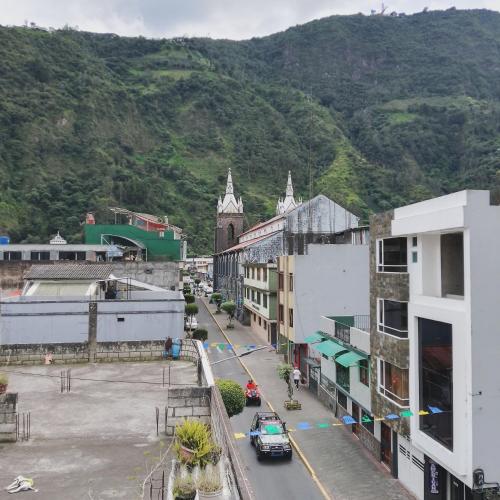 an aerial view of a city with a mountain at Hotel Amazonia y sol in Baños