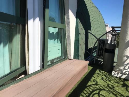 an open window on a house with a wooden deck at Savoy Hotel in Chişinău