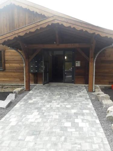 un grand bâtiment en bois avec une grande porte ouverte dans l'établissement Duplex dans chalet, vue de rêve, 6 pers, 2 nuits minimum, à La Bresse