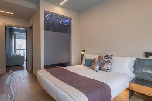 a bedroom with a large bed and a window at Luci Sul Mare -Boutique Rooms in Follonica