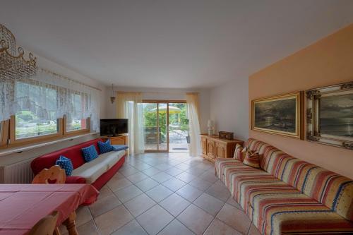a living room with two couches and a tv at Residence Obermoarhof - Family Apartments with Pool & Playground in Vandoies