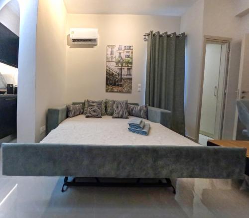 a large bed in a room with a bedvisor at Katia Athens Apartment in Athens