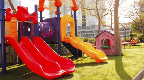 a playground with two slides and a play structure at Dusit Thani Dubai in Dubai