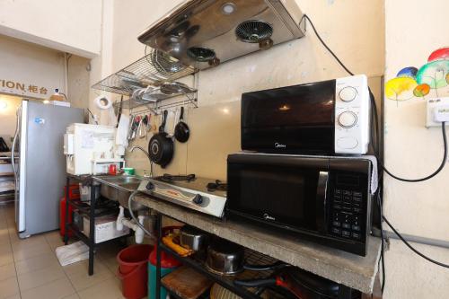 a microwave sitting on a counter in a kitchen at Dou Houz Georgetown in George Town