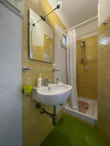a bathroom with a white sink and a shower at Medioevo Mare in Pisciotta