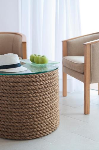 a table with a bowl of apples on top of it at Azia Resort & Spa in Paphos City