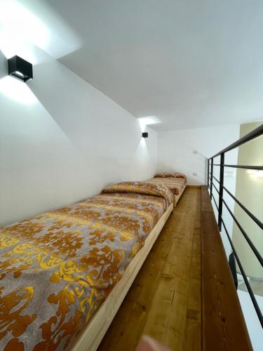 a long bed in a room with white walls at Cozy Studio in Pisciotta