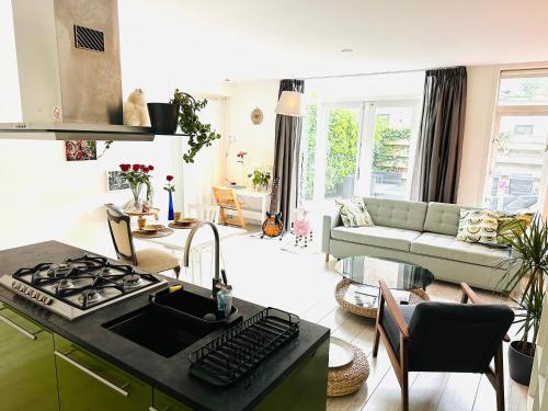 a kitchen and living room with a stove top oven at Perfectly located charming apartment MAGDALENA HOUSE for true connoisseurs in Haarlem