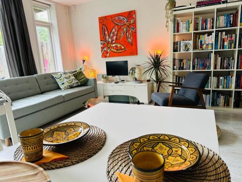 a living room with a couch and a table at Perfectly located charming apartment MAGDALENA HOUSE for true connoisseurs in Haarlem