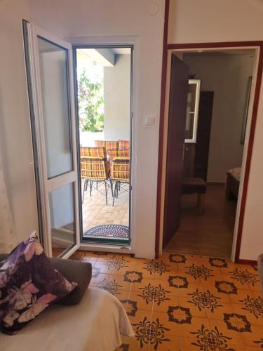 a room with a door leading to a patio with a table at Summer rental house "Kava" in Okrug Donji